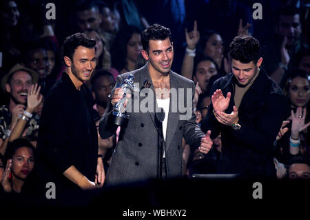 Kevin Jonas (left), Joe Jonas and Nick Jonas of the Jonas Brothers collect their award for Best Pop Video on stage at the MTV Video Music Awards 2019 held at the Prudential Center in Newark, New Jersey. Stock Photo