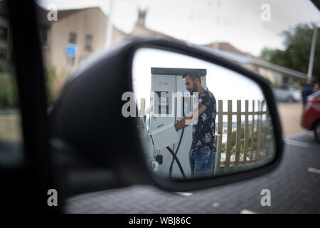 Abdullah Kamer, delivery driver, charges his electric work car at the Princes Street Electrical Charging Station, one of three such stations in the city, in Dundee, Scotland, on 14 August 2019. Stock Photo