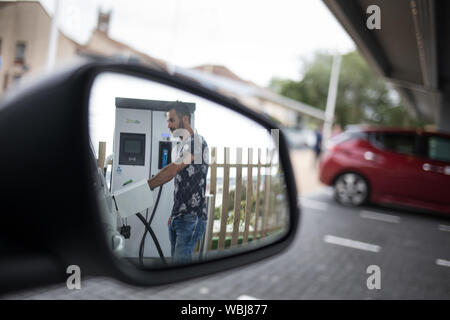 Abdullah Kamer, delivery driver, charges his electric work car at the Princes Street Electrical Charging Station, one of three such stations in the city, in Dundee, Scotland, on 14 August 2019. Stock Photo
