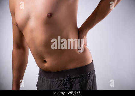 The man suffering from backbain on gray Stock Photo