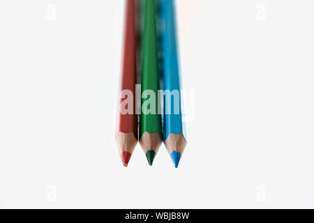 Red, green and blue coloured pencils against a white background Stock Photo