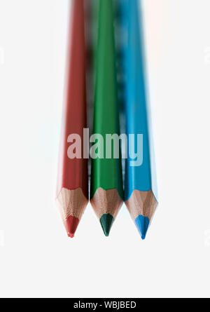 Red, green and blue coloured pencils against a white background Stock Photo