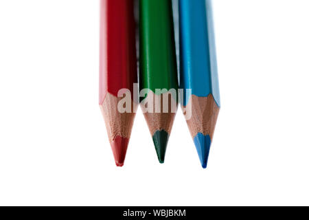 Red, green and blue coloured pencils against a white background Stock Photo