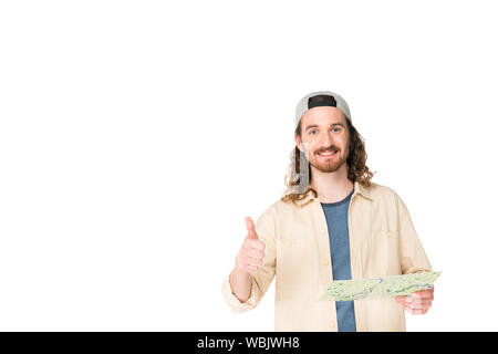 front view of young man smilling at camera, holding map and showing thumb up isolated on white Stock Photo