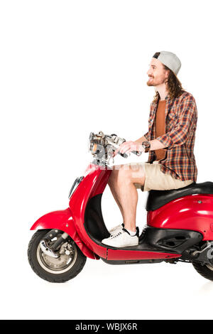 side view of young man sitting on red scooter isolated on white Stock Photo