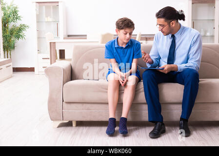 The internet addicted boy visiting male doctor Stock Photo