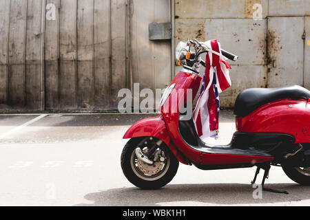 red scooter with American flag on handle Stock Photo