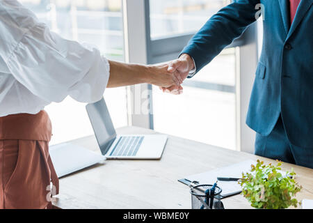 cropped view of employee and recruiter shaking hands in office Stock Photo