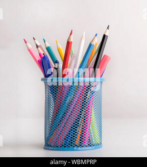 Close up of colored pencils in blue transparent stand on white Stock Photo