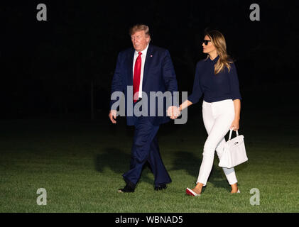 Washington DC, USA. 26th Aug, 2019. United States President Donald J. Trump and first lady Melania Trump hold hands as they return to the White House after attending the G7 Summit in Paris, on August 26, 2019 in Washington, DC. Credit: MediaPunch Inc/Alamy Live News Stock Photo