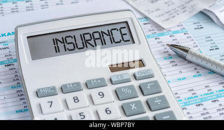 A calculator with the word Insurance on the display Stock Photo