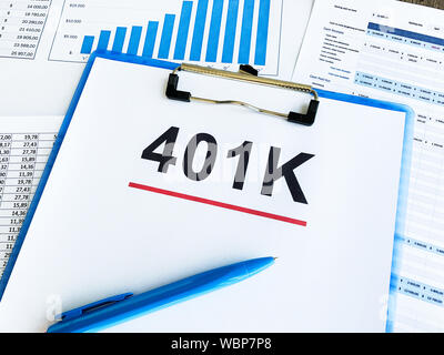 Paper with 401k plan on wood table Stock Photo