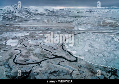 Aerial - rivers, snow and mountains, Hellisheidi, Iceland Stock Photo