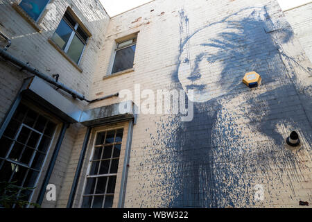 A Banksy mural, "The girl with the pierced eardrum" on a building in Bristol, England Stock Photo