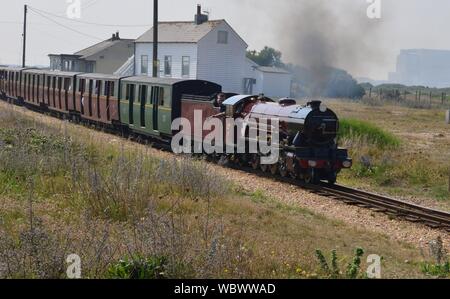 Narrow gauge steam locomotive pulling a coach train. A Narrow gauge steam locomotive pulling a train on the Romney, Hythe and Dymchurch railway Stock Photo