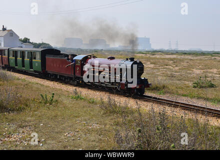 Narrow gauge steam locomotive pulling a coach train. A Narrow gauge steam locomotive pulling a train on the Romney, Hythe and Dymchurch railway Stock Photo