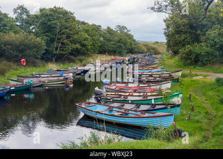 Rowing boats moored on the small creek seperating Ross Island from the mainland, Lough Leane, Killarney National Park, County Kerry, Ireland. Stock Photo