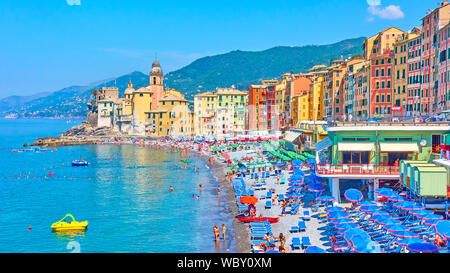 Camogli, Genoa, Italy - July 3, 2019:  Beach with resting people and waterfront in Camogli near Genoa city on sunny summer day, Liguria Stock Photo