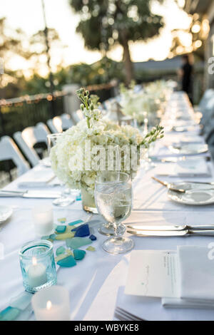Table set up for outdoor sunset wedding reception Stock Photo