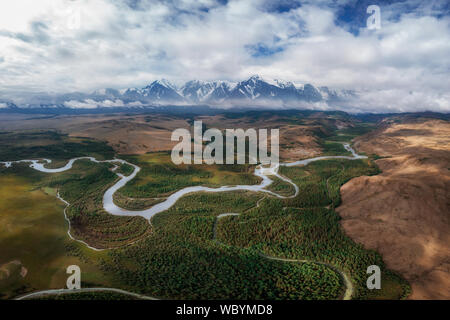 Kurai steppe and Chuya river on North-Chui ridge background. Altai mountains, Russia. Aerial drone panoramic picture. Stock Photo