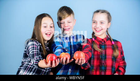 School snack time. Boy and girls friends eat apple snack. Teens with healthy snack. Apple fruit has numerous benefits. Vitamin nutrition concept. Eat fruit and be healthy. Having tasty snack. Stock Photo