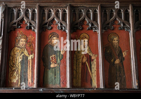 Medieval church paintings on a Rood Screen. UK L-R  of An Archbishop, A Saint possibly St James the Less or St Simon, St Philip with tall cross, St Thomas with carpenters square. Strensham Worcestershire Church of St John the Baptist. HOMER SYKES Stock Photo