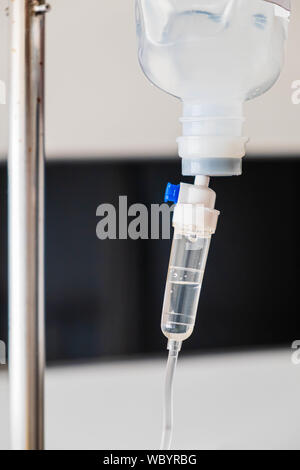 IV intravenous bag with dropper and tube dispose with medicine solution close up Stock Photo