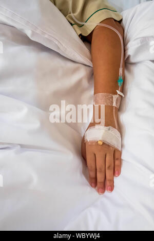 Patient in hospital in bed with intravenous medicine close up Stock Photo