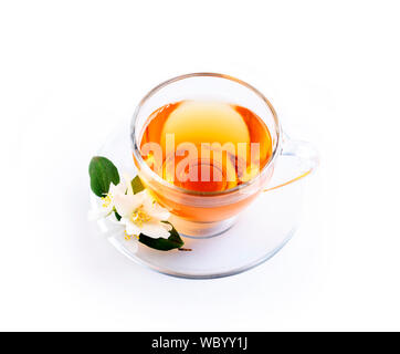 Asian green tea with jasmine flower in transparent teacup isolated on white background with reflection. Traditional chinese hot beverage in glass cup Stock Photo