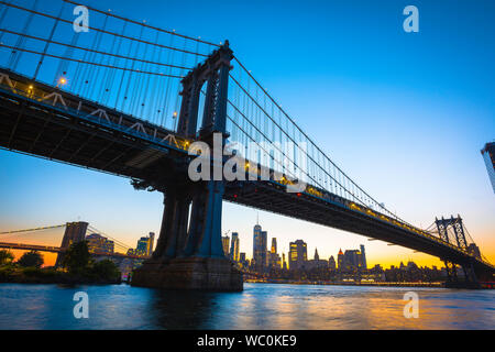 Manhattan Bridge, view at night from Brooklyn of the Manhattan Bridge with the skyline of Lower Manhattan in the distance, New York City, USA Stock Photo