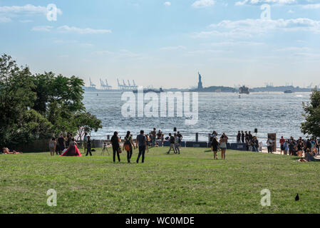 Brooklyn Bridge Park, view in summer of people walking on the Harbor View Lawn in Brooklyn Bridge Park, New York City, USA. Stock Photo