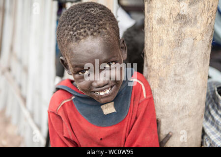 PANWEL, SOUTH SUDAN-NOVEMBER 2, 2013: Portrait of young boy of the Dinka tribe in a village in South Sudan Stock Photo