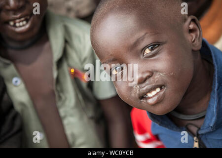 PANWEL, SOUTH SUDAN: NOVEMBER 2, 2013: Portrait of a curious little boy of the Dinka tribe in a rural area of South Sudan Stock Photo
