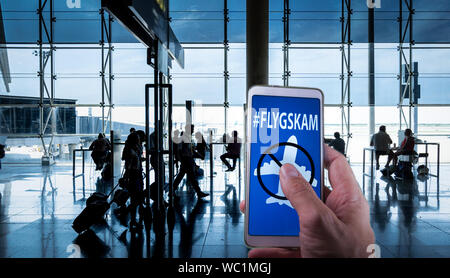 Tourist applying for eta united kingdom visa using mobile phone at airport Stock Photo