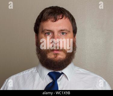bearded professional wearing a tie during his day at work Stock Photo