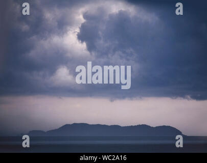 Gathering storm clouds over a tropical island, East coast Malaysia Stock Photo