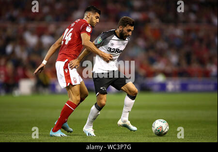 Nottingham Forest's Rafa Mir (left) and Derby County's Graeme Shinnie battle for the ball during the Carabao Cup Second Round match at the City Ground, Nottingham. Stock Photo