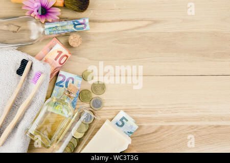 Set of different zero waste beauty products on wooden background with euro money bank notes around them, zero waste sustainable lifestyle true cost co Stock Photo