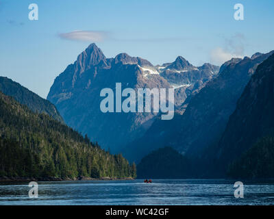 Ecotourists in a small boat cruising up Patterson Bay on Baranof Island in Southeast Alaska, USA Stock Photo