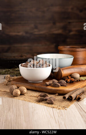 Black Indian Cardamon Pods in a bowl and food preparation and kitchen setting Stock Photo