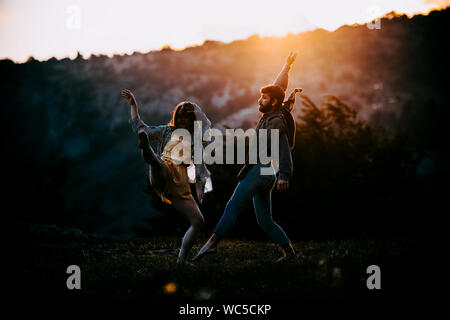 Summer holidays, teenage and dancing concept - couple of teenagers dancing outside Stock Photo