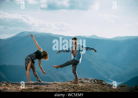 Two athletic young dancers making a performance at mountain peak Stock Photo