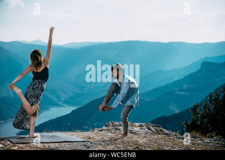 Two athletic young dancers making a performance at mountain peak Stock Photo