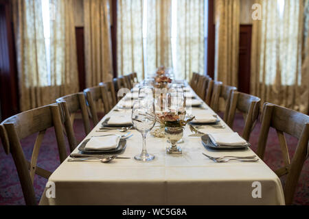 Long table set up for holiday dinner Stock Photo