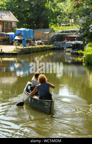 BATH, ENGLAND - JULY 2019: People paddling a canoe on the Somerset Coal Canal near the city of Bath Stock Photo