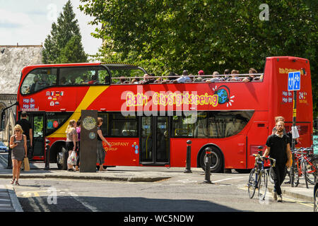 BATH, ENGLAND - JULY 2019: Bath Sightseeing double deck open topped bus carrying visitors around the city of Bath. Stock Photo