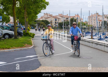 La Rochelle, France - May 07, 2019: Elderly couple rides on bikes near Port des Minimes in La Rochelle, France Stock Photo