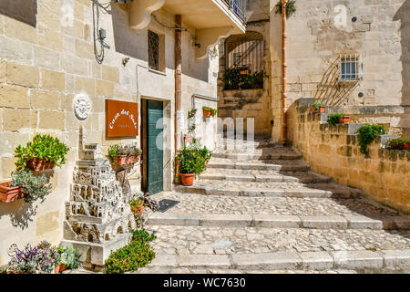 A shop featuring a scale model of the ancient sassi in an alley inside the historic old town of Matera, Italy in the Basilicata region, an Unesco site Stock Photo