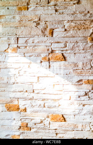 Pattern of modern stone wall indoor with light from window Stock Photo