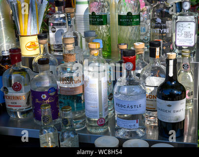 Various bottles of Gin on the bar counter at aa open air bar at Overton, Basingstoke, Hampshire, England, UK Stock Photo